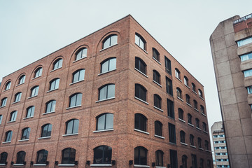 Three modern large buildings under overcast sky