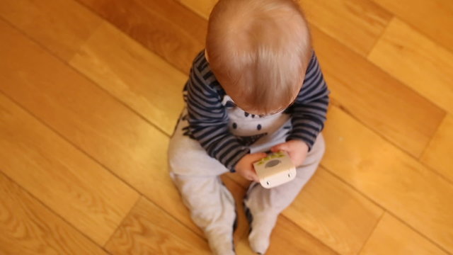 Little cute boy playing at home with toy