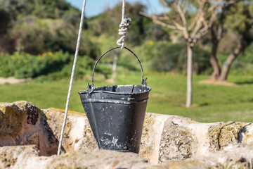 Ancient water well with a bucket