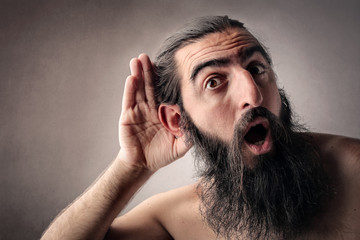 Long-bearded man listening