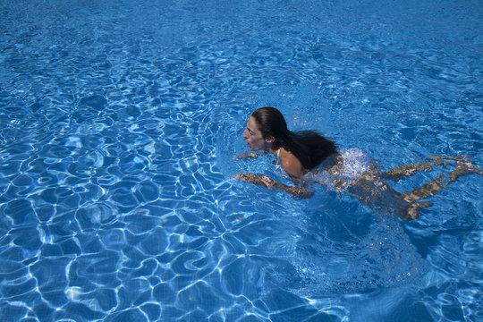 woman swimming breaststroke in a pool
