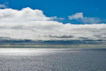 Seascape with blue sky and white clouds