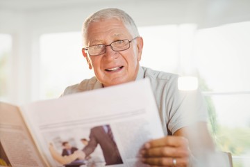 Fototapeta na wymiar Focused senior man reading newspaper