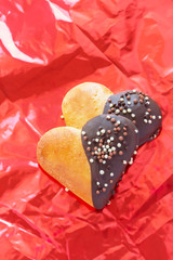 sweet pastries with chocolate in a heart shape on a red background