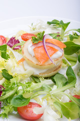 green salad with eggs in the shape of a heart, salmon, cherry tomatoes