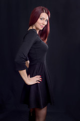 Fototapeta premium Beautiful redhead posing in a dark shot 