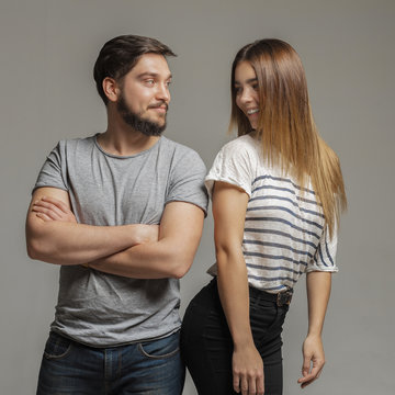 Casual loving couple on grey background