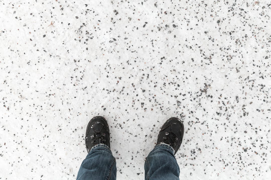 Male feet standing on snowy winter road