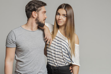 Casual loving couple on grey background