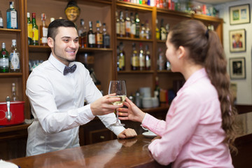 Female drinking wine at counter