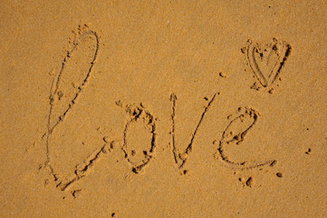 love word written on brown sand