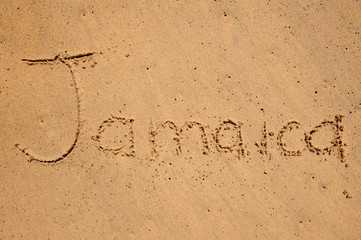 jamaica written on a beach sand
