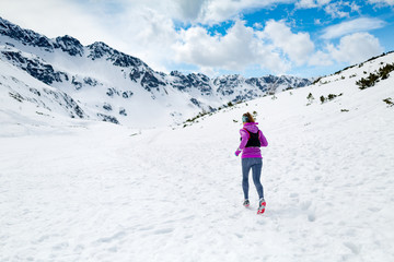Fototapeta na wymiar Winter running woman. Trail runner inspiration, sport and fitnes