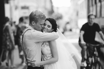 Groom hugs bride