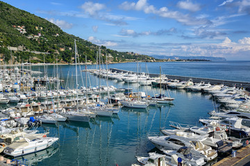 Fototapeta na wymiar White yachts docked in port of Alassio on Riviera, Italy