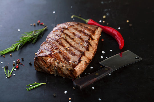 Grilled Beef Steak with spices, rosemary and chili peppers