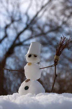 little snowman with broom