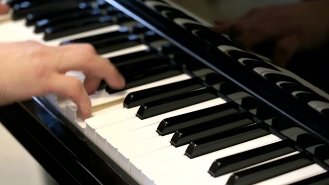 Playing a black piano.
