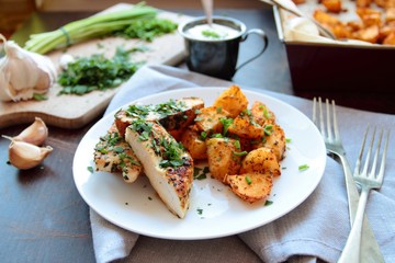 Grilled chicken breast filet with potatoes with herbs