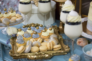 Fototapeta na wymiar dessert buffet muffins, cookies, macaroon on a festive table