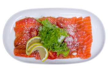 Salmon carpaccio with lemon, top view, isolated