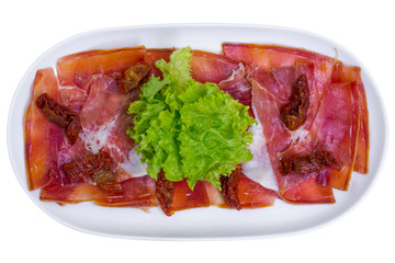 Hamon meat snack (jamon) in white plate, top view