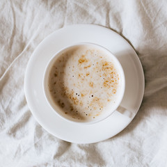 Top view of Cup of coffee for breakfast on bed