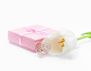 Fresh tulip flower and heart and gift. St. Valentines or love concept. On the white.