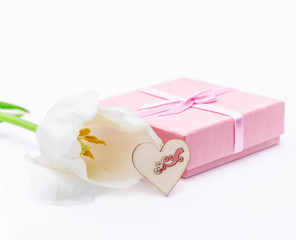 Fresh tulip flower and fabric heart and gift. St. Valentines or love concept. On the white.
