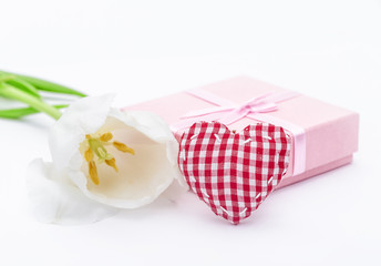 Fresh tulip flower and fabric heart and gift. St. Valentines or love concept. On the white.