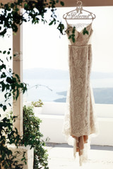 Elegant vintage white dress hanging on terrace with sea in backg