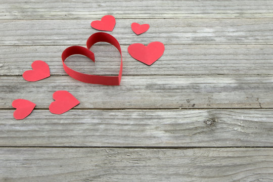 Red hearts on wood background