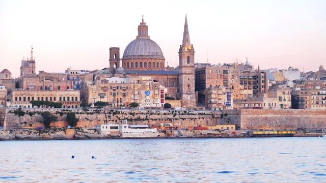 View on Valletta St. Paul's Anglican Cathedral and belltower of Charmelite Church from Sliema embankment  at the Evening time, Malta
