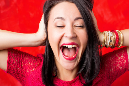 Excited woman holding her head 