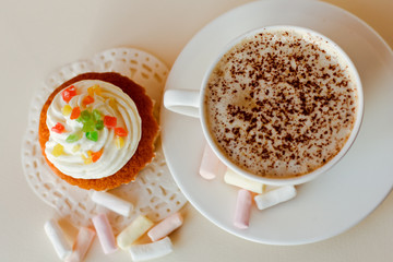 Beautiful coffee Cup with heart cupcake on white wooden background