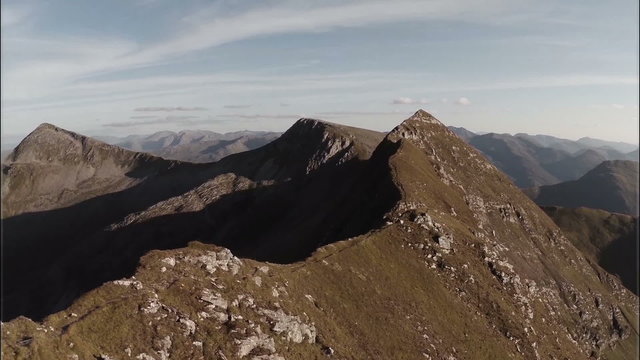 Spectacular aerial shot on Sgurr a'Mhaim mountain revealing devils ridge in the Scottish highlands during sunset
