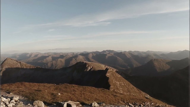 Spectacular aerial shot on Sgurr a'Mhaim mountain in the Scottish highlands during sunset
