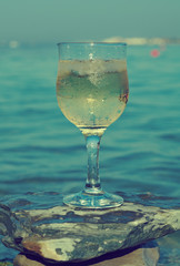Glass of white wine by the coast