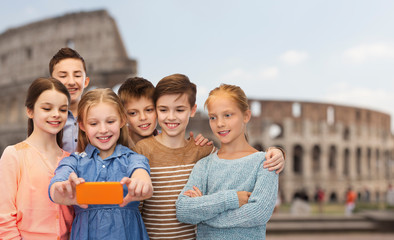 children talking smartphone selfie over coliseum