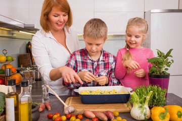 Mother with children baking together 