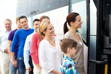 group of happy passengers boarding travel bus