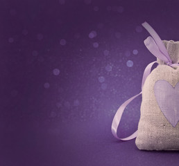 Bag with a painted heart on the shiny background. 