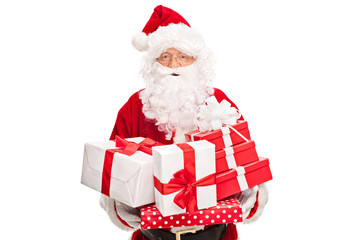 Santa Claus holding a bunch of presents