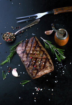 Grilled beef steak with spices, garlic and rosemary