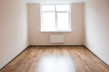 Empty room with window and wooden floor