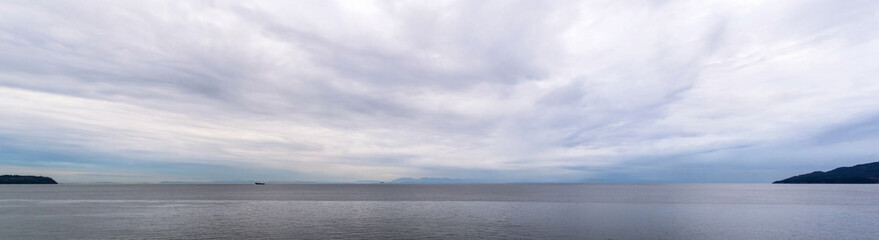 panoramic view of the coast of british columbia with vancouver island on the horizon and two tanker ship