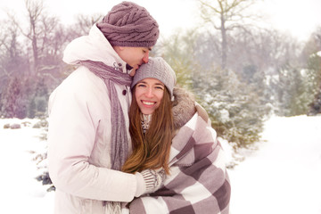 Obraz premium Happy couple in love in park in winter with light leaks