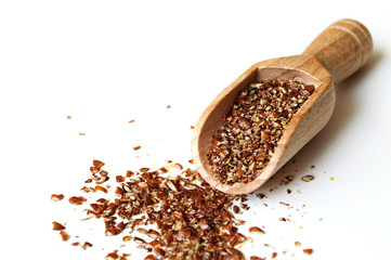 Ground flax seeds in wooden scoop