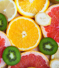 Citrus fruit background with a group of oranges lemons lime tangerines and grapefruit as a symbol of healthy eating and immune system boost with natural vitamins