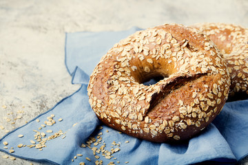 Wholegrain rye bread with seeds on blue napkin background Copy space